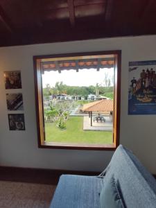 a window in a room with a view of a park at Casa Larrosa Itaúna Adults Only in Saquarema
