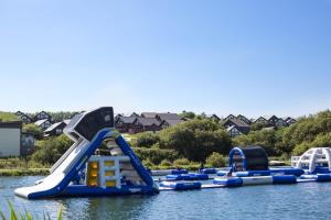 a row of inflatable slides in the water at Retallack Resort by Away Resorts in Padstow