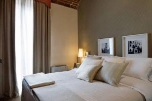 a large white bed in a room with a window at Albergo D'italia in Chivasso