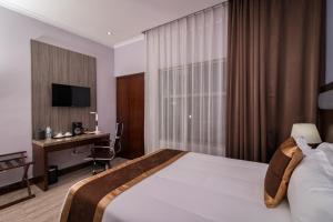 Postel nebo postele na pokoji v ubytování Hotel City Plaza & Suites