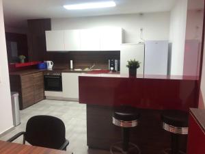 a kitchen with a counter and stools in it at KS GbR Wohnungen in Mechernich