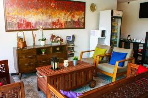 a living room with two chairs and a table at Potpourri Boutique Hotel in Johor Bahru