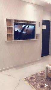 a flat screen tv on a wall in a living room at Juri Ahla Al Masayef Furnished Units in Taif