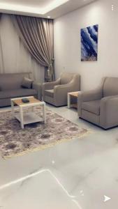 a living room with couches and a coffee table at Juri Ahla Al Masayef Furnished Units in Taif
