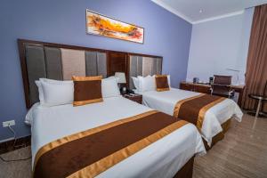 Postel nebo postele na pokoji v ubytování Hotel City Plaza & Suites