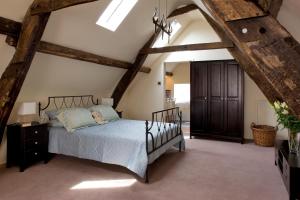 a bedroom with a large bed in a attic at Morton House 4brm and Stable Block 3brm in Masham - 2-15 guests in Masham