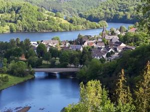 a town in the middle of a river with a bridge at Garni Hotel im Fachwerkhof in Einruhr