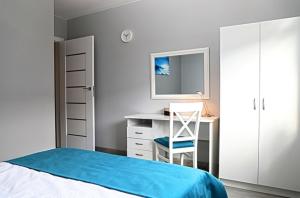 A bed or beds in a room at Apartament Blue Bay 2-pokojowy