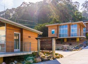 a wooden building with a sign in front of it at Anchor Inn Pacifica in Pacifica