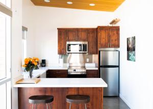 a kitchen with wooden cabinets and stainless steel appliances at Anchor Inn Pacifica in Pacifica