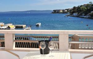 un tavolo con 2 bicchieri da vino sul balcone di Sea View Apartments Sirena Okrug Gornji a Okrug Gornji