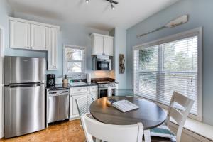a kitchen with a table and chairs and a refrigerator at Altitude Adjustment in Santa Rosa Beach
