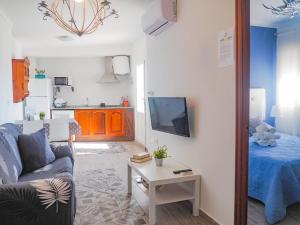 a living room with a couch and a table at ConilPlus apartment SANTA CATALINA III in Conil de la Frontera