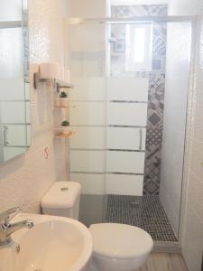 a bathroom with a toilet and a sink at ConilPlus apartment SANTA CATALINA III in Conil de la Frontera