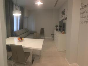 a living room with a white table and a couch at CASA DE TOSCA in Lucena