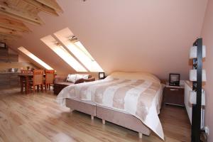 a bedroom with a bed and a dining room at Apartamenty & Restauracja NADMORSKA in Krynica Morska +30 photos