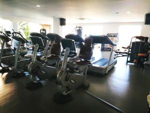 a gym with several treadmills and cardio machines at Praia da Luz Monique Apartment in Luz