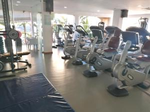a gym with several rows of tread machines at Praia da Luz Monique Apartment in Luz