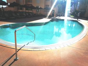 a large swimming pool in the middle of a building at Praia da Luz Monique Apartment in Luz