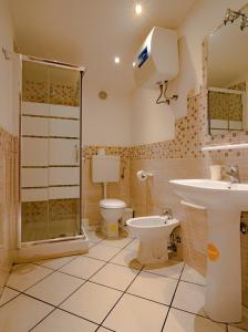 a bathroom with a shower and a toilet and a sink at Vesta-Apartments in Catania