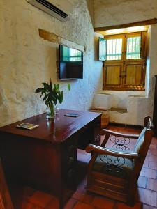 a room with a wooden desk with a plant on it at Hotel Boutique Casa de Los Santos Reyes Valledupar in Valledupar