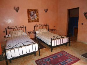 Voodi või voodid majutusasutuse Hotel Riad L' Arganier D' Or toas