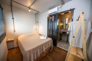 a room with a bed and a mirror in it at Eco Hostel & Suítes in São Miguel do Gostoso