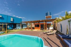 a swimming pool on a patio next to a house at Eco Gostoso in São Miguel do Gostoso