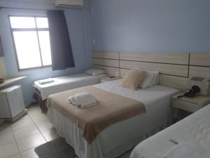 Postel nebo postele na pokoji v ubytování Esplendor Palace Hotel