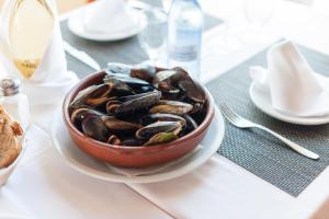 a bowl of mussels on a plate on a table at Alcudia Petit - Turismo de Interior in Alcudia