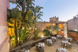 an outdoor patio with tables and chairs and a building at Alcudia Petit - Turismo de Interior in Alcudia