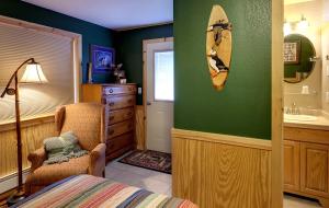 a bathroom with a bed and a surfboard on the wall at Sea Parrot Inn in Seldovia +40 photos