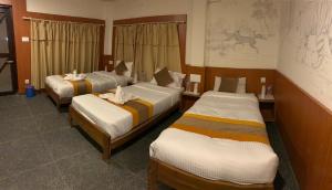 Lova arba lovos apgyvendinimo įstaigoje Rhino Lodge Bardia Pvt Ltd