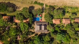 an aerial view of a house with a blue roof at La Folie Lodge in Champasak