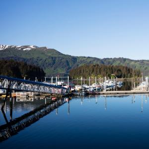 a bridge over a body of water next to a marina at Sea Parrot Inn in Seldovia