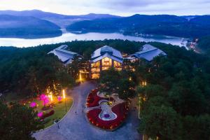 an aerial view of a building with a view of a lake at Terracotta Hotel & Resort Dalat in Da Lat
