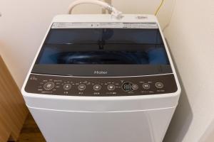 a washing machine is sitting on a wall at Mr KINJO 万座ビーチ前 in Onna