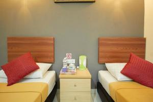 Postel nebo postele na pokoji v ubytování COOP HOTEL PUTRAJAYA & CYBERJAYA