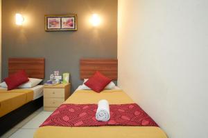 Postel nebo postele na pokoji v ubytování COOP HOTEL PUTRAJAYA & CYBERJAYA