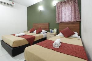 Postel nebo postele na pokoji v ubytování COOP HOTEL PUTRAJAYA & CYBERJAYA