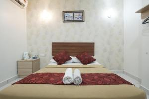 Postel nebo postele na pokoji v ubytování COOP HOTEL PUTRAJAYA & CYBERJAYA