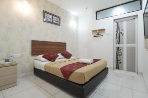 Postel nebo postele na pokoji v ubytování COOP HOTEL PUTRAJAYA & CYBERJAYA