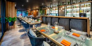 a restaurant with tables and chairs and a bar at Diamond Condo by VС in Bang Tao Beach