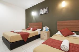 Postel nebo postele na pokoji v ubytování COOP HOTEL PUTRAJAYA & CYBERJAYA