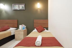 Postel nebo postele na pokoji v ubytování COOP HOTEL PUTRAJAYA & CYBERJAYA