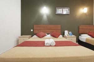 Postel nebo postele na pokoji v ubytování COOP HOTEL PUTRAJAYA & CYBERJAYA