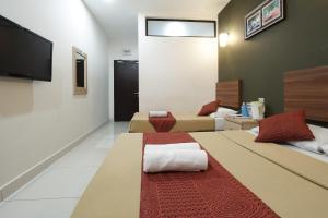 Postel nebo postele na pokoji v ubytování COOP HOTEL PUTRAJAYA & CYBERJAYA