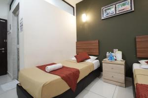 Postel nebo postele na pokoji v ubytování COOP HOTEL PUTRAJAYA & CYBERJAYA