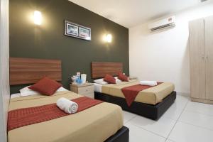 Postel nebo postele na pokoji v ubytování COOP HOTEL PUTRAJAYA & CYBERJAYA