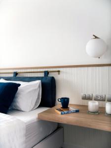 a bedroom with a bed with a wooden tray on it at BLU 395 Ari-Saphan Khwai in Bangkok +17 photos